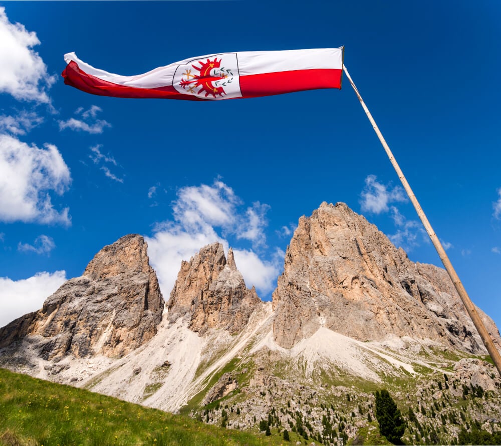 South Tyrolean Flag in front of Sassolungo massif