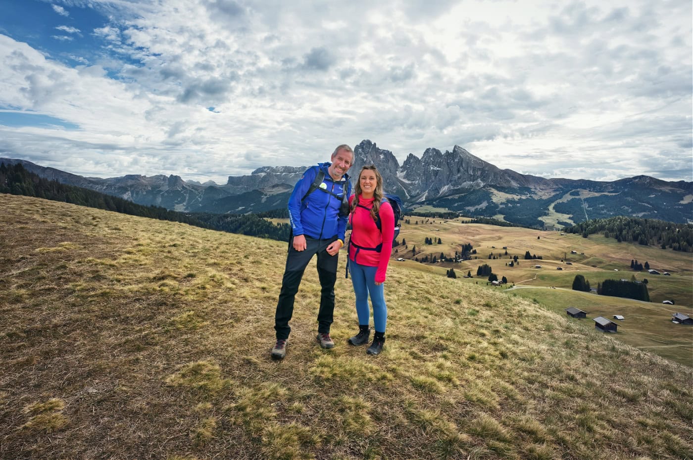 Aquila Dolomites Residence: Ortisei Below, the Dolomites Beyond, and You in Between 16 Kate and Theo standing in front of the Sassolungo massif on Alpe di Siusi.
