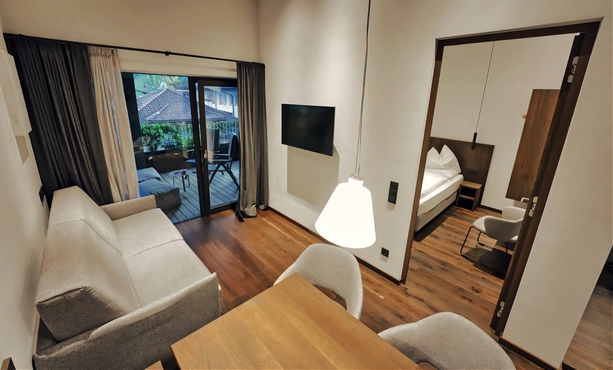 Aquila Dolomites Residence: Ortisei Below, the Dolomites Beyond, and You in Between 6 A penthouse living room at the Aquila Dolomites Residence in Ortisei.