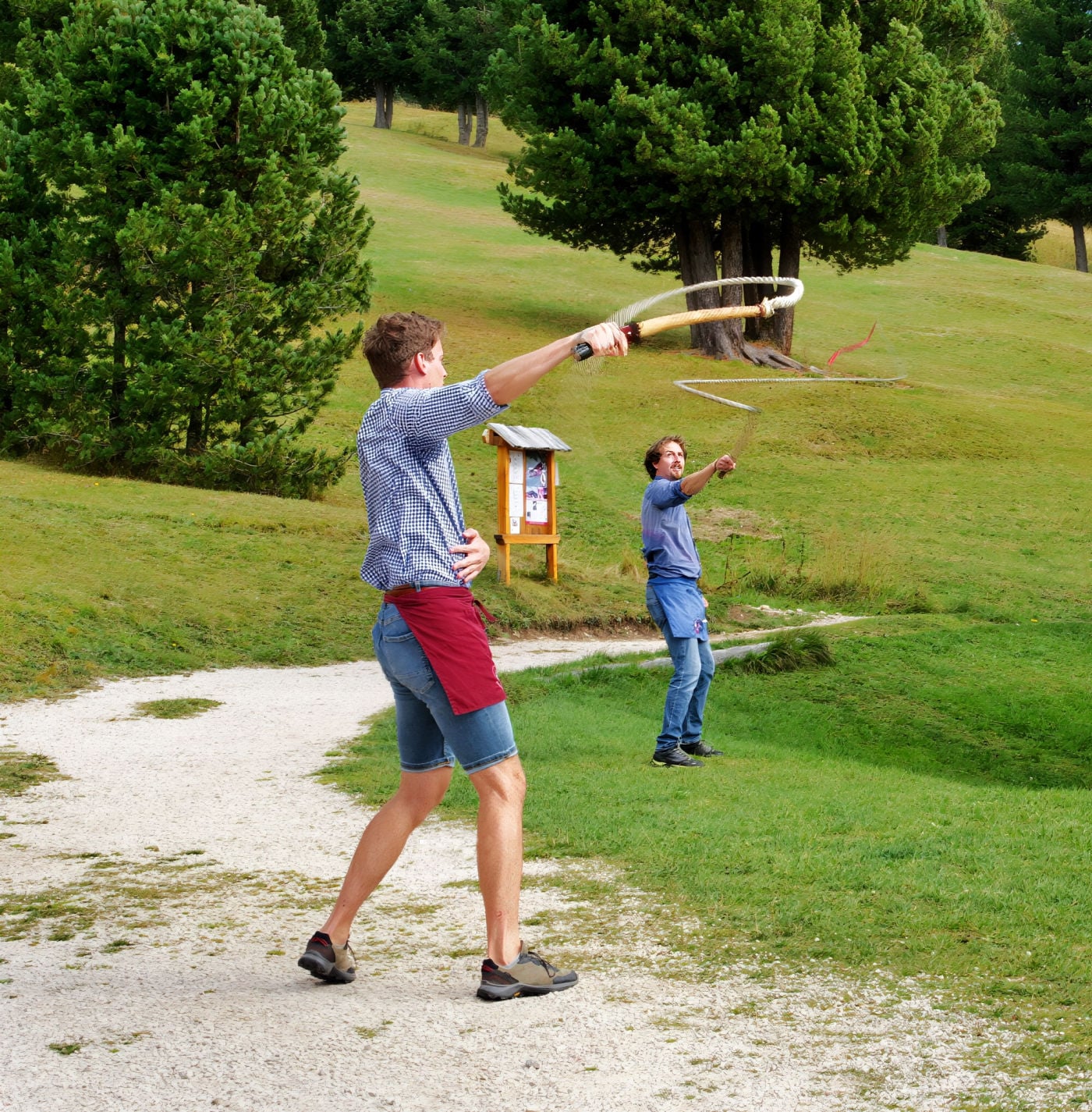 Whip crackers performing at Baita Seurasas Hütte in the Dolomites.