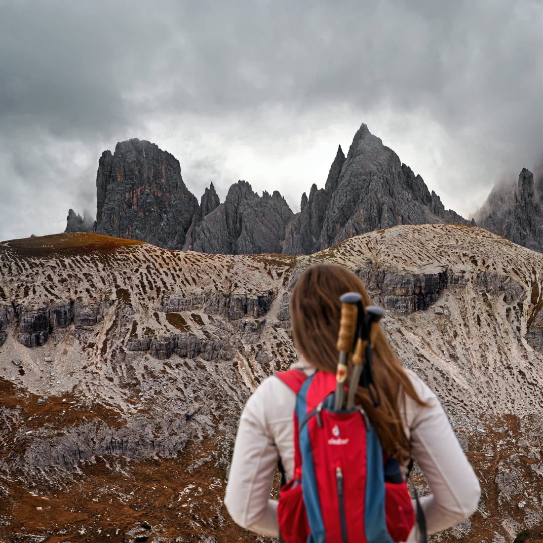 A female hiker admiring the peaks of Cadini di Misurina.