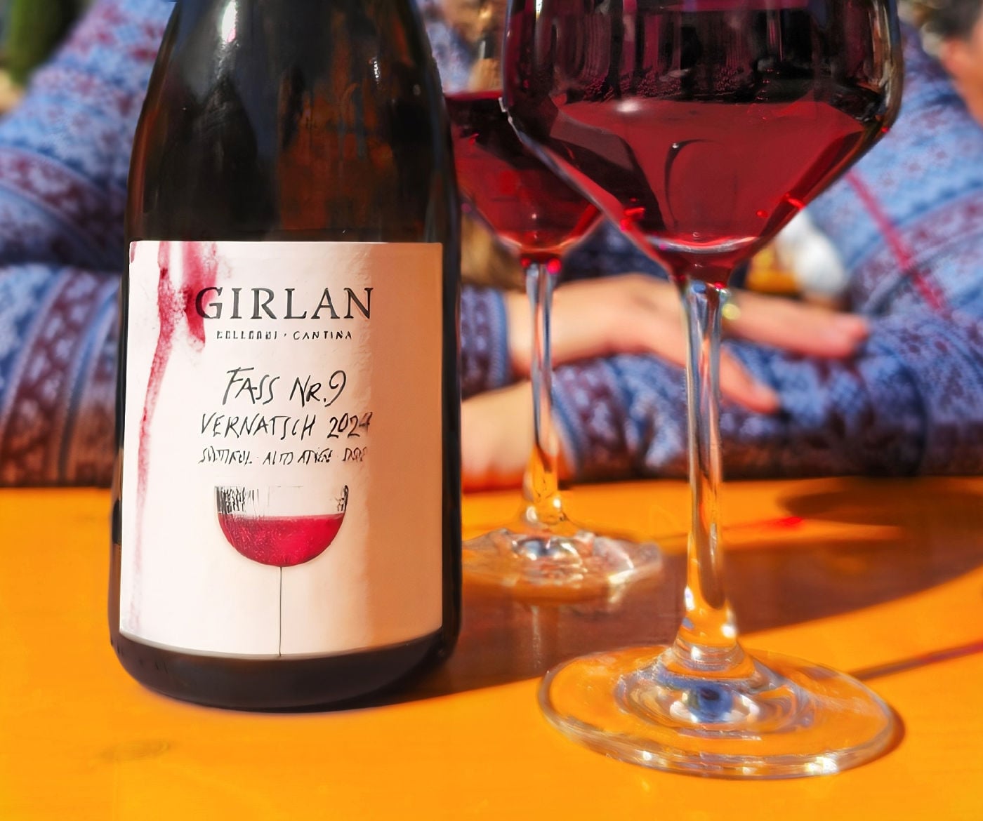 From Vine to Village: Raise a Glass at South Tyrol's Last Load of Grapes Festival 3 Two glasses of Cantina Girlan Vernatsch and the its wine bottle.