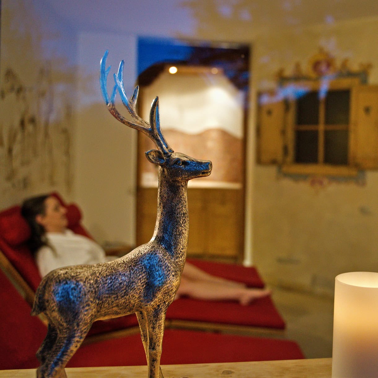 A woman relaxing at a wellness resort in the winter in the Dolomites. 
