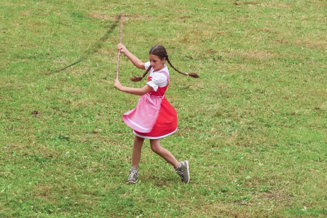 A girl competes at whip cracking in South Tyrol. 