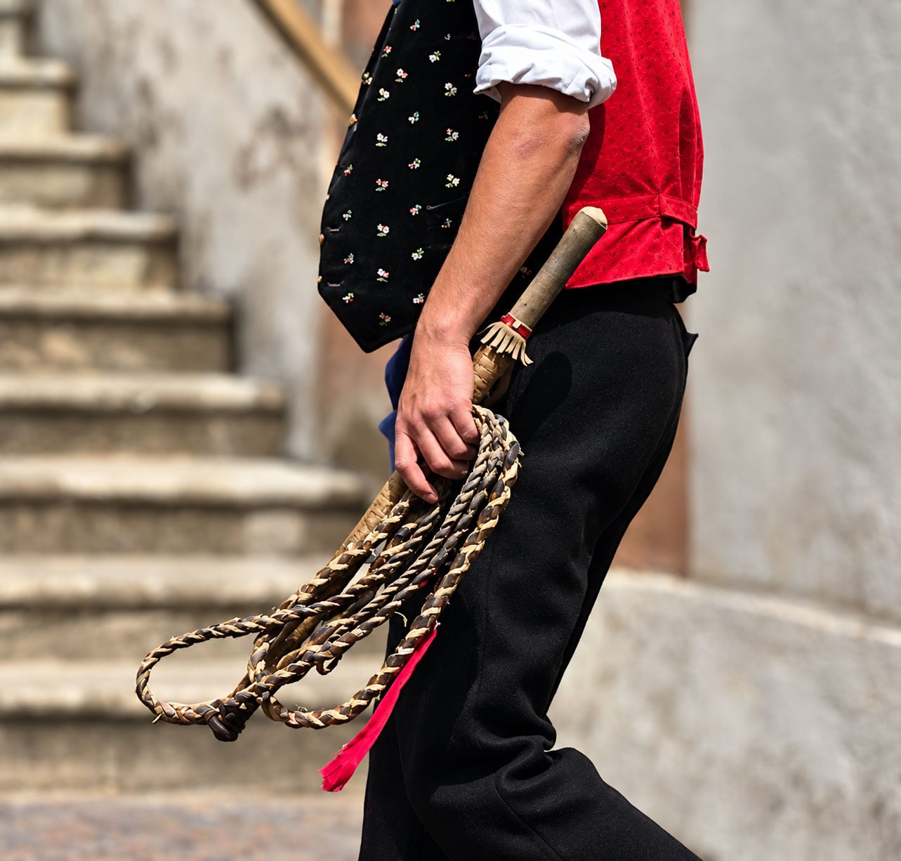 A  Goaslschnöller in Castelrotto holding his Goaßl (whip).