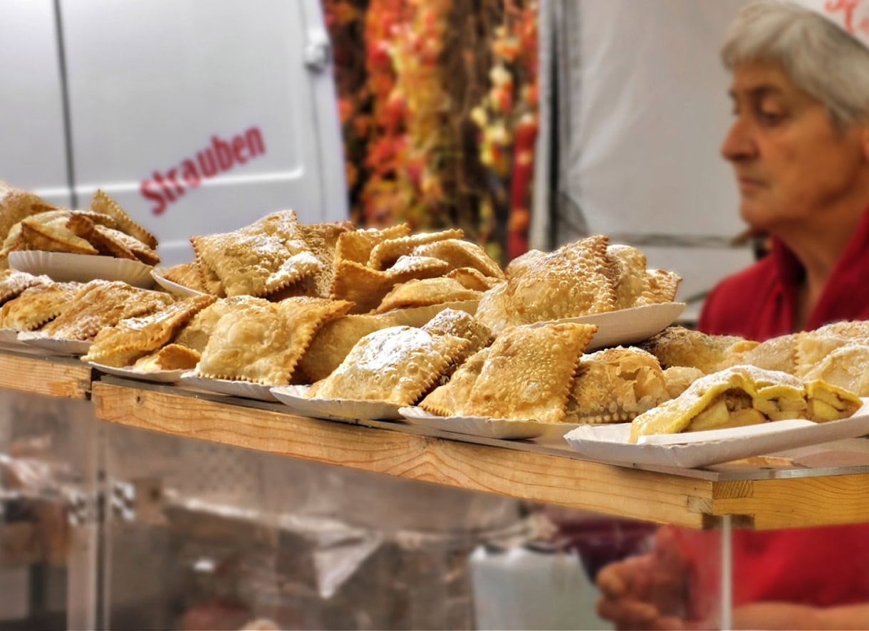 Sweet Summit: 8 Must-Try Desserts in South Tyrol & the Dolomites 16 A Krapfen dessert stand at a festival in South Tyrol.