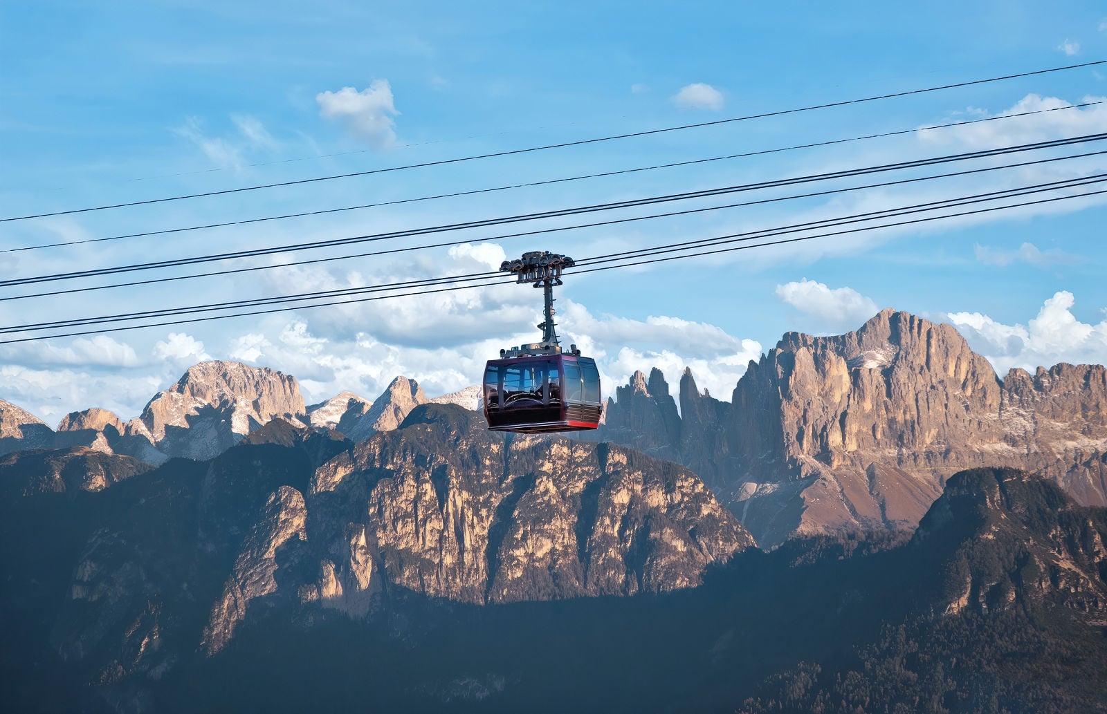 Earth Pyramids of Renon: How to Visit South Tyrol's Strangest Natural Wonder 5 Renon cable car climbing above Bolzano with the Rosengarten Group in the background