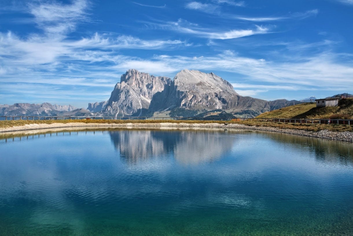 The Sassolungo Group reflecting in a pond on Alpe di Siusi.