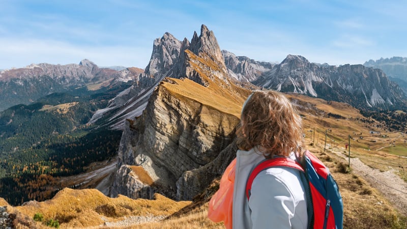 A woman at the famous viewpoint of Seceda in the Dolomites.