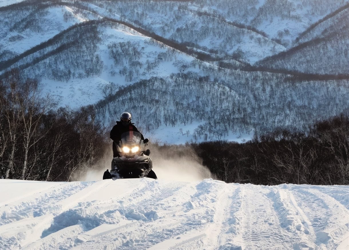 A person riding snowmobile in the Dolomites. 