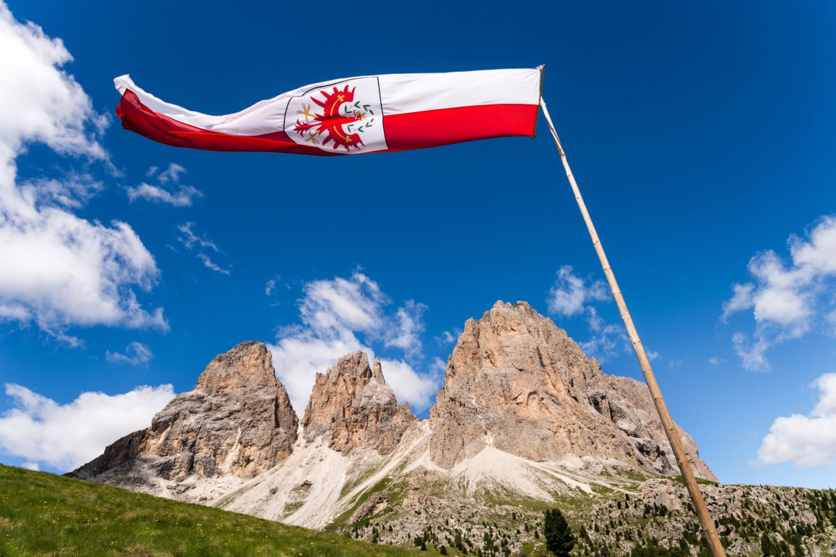 The South Tyrolean flag flying above the Langkofel / Sassolungo massif in South Tyrol. 