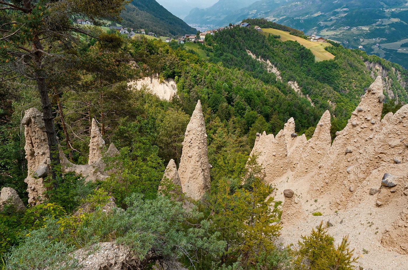 Earth Pyramids of Renon: How to Visit South Tyrol's Strangest Natural Wonder 8 Earth pyramids at Steinegg in Val d’Ega, South Tyrol, rising from a forested clay hillside