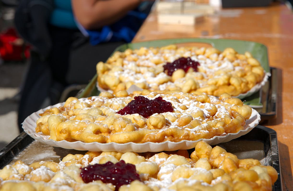 Sweet Summit: 8 Must-Try Desserts in South Tyrol & the Dolomites 11 A row of Strauben plates at a festival in South Tyrol.