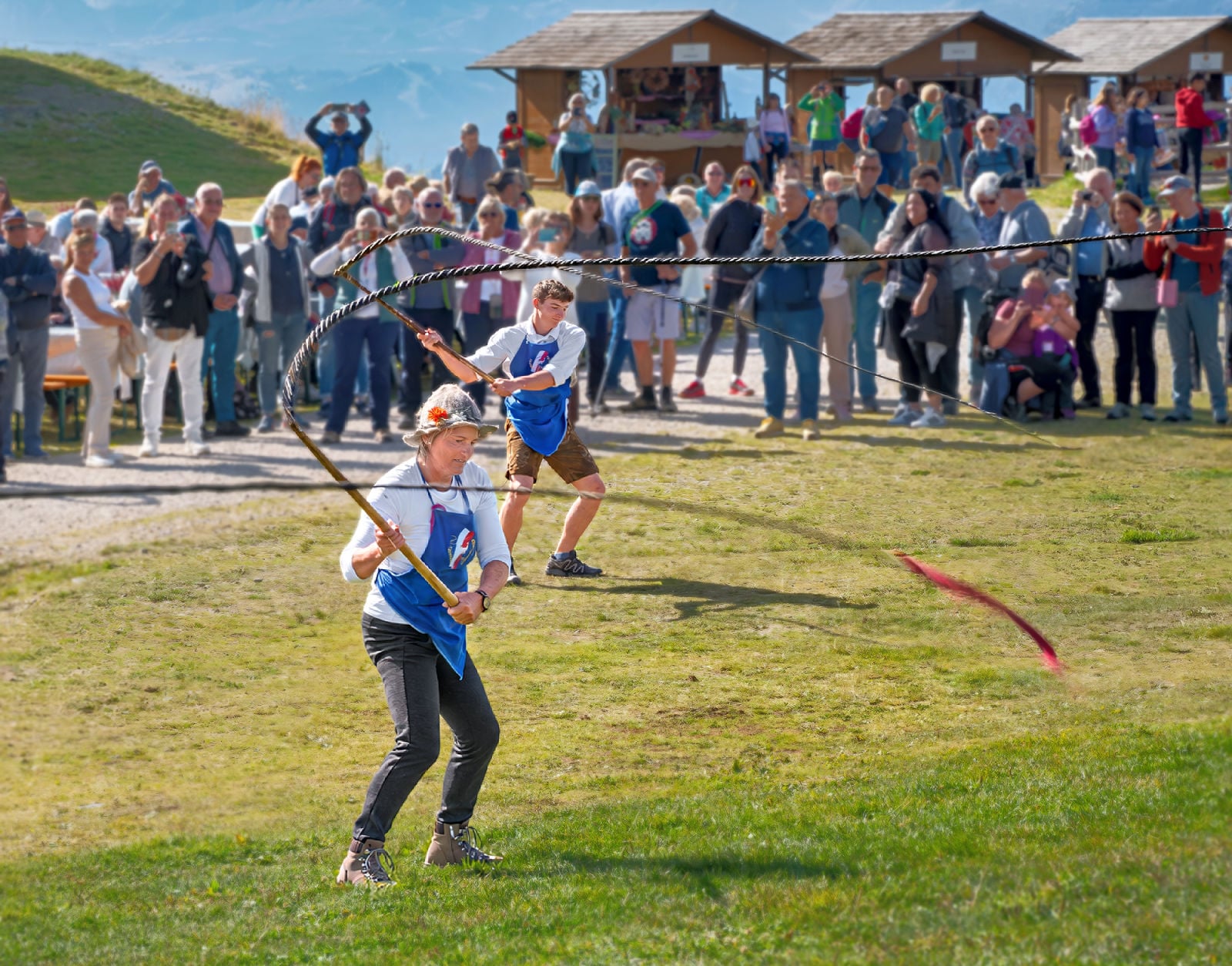 Goaslschnöllen performers whip cracking at festival in South Tyrol.